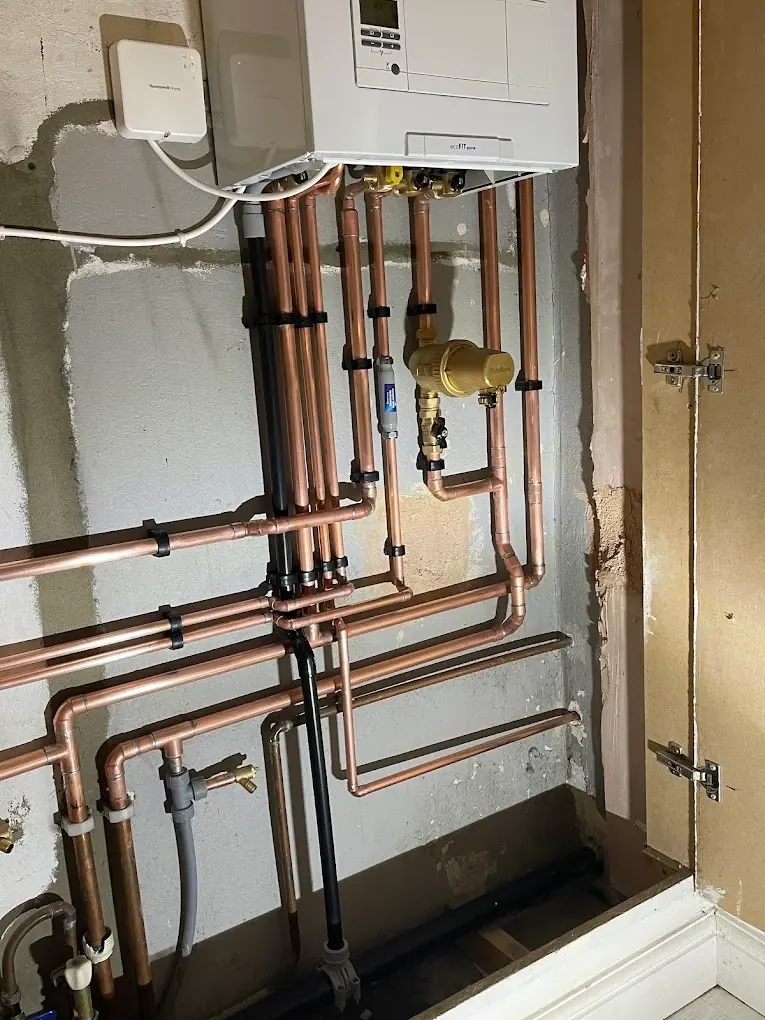 Boiler cupboard with full copper pipework manifold and gas run during installation