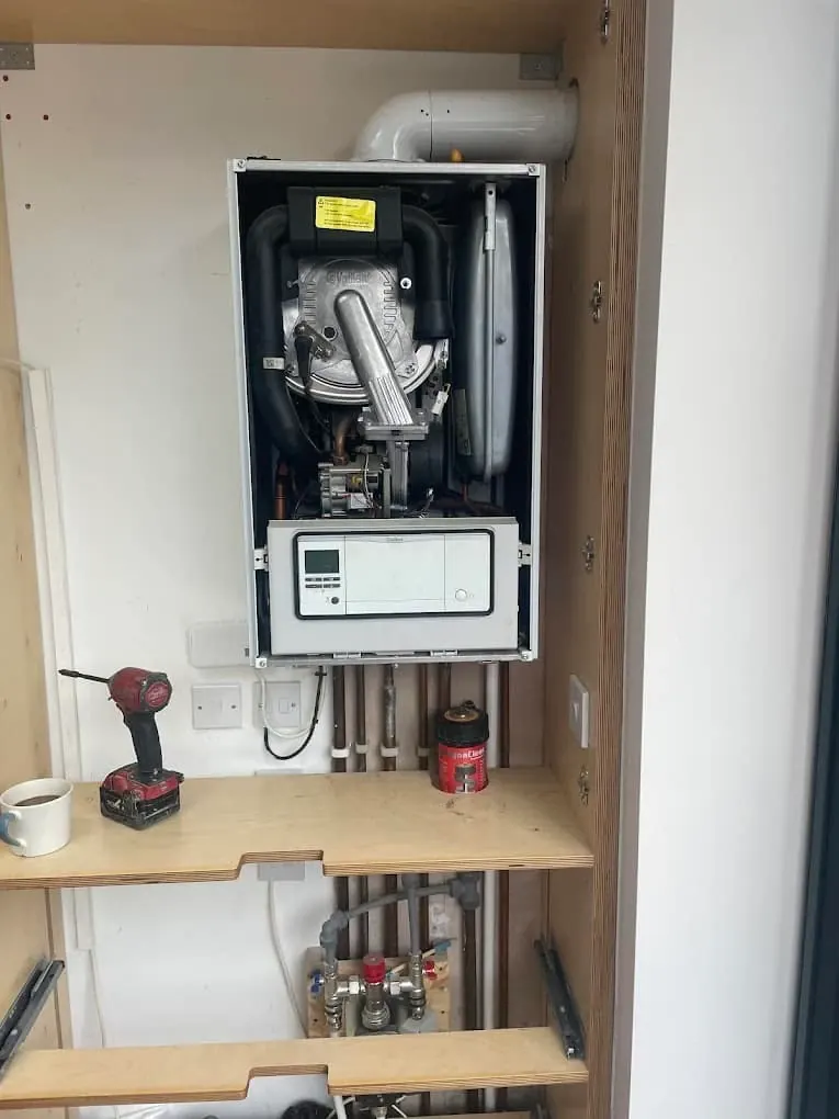 Boiler with casing removed during service showing heat exchanger and fan