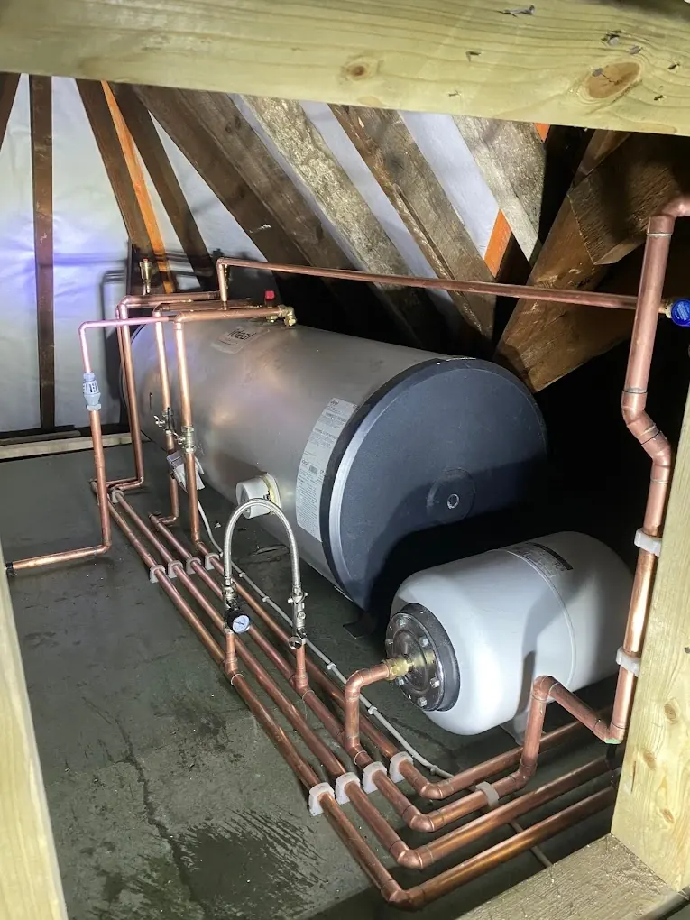 Loft-mounted horizontal cylinder and expansion vessel with copper pipework runs